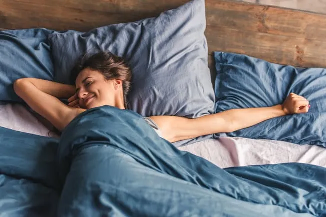 1800ss thinkstock rf woman stretching in bed