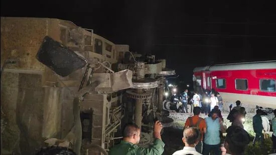 Passengers near the derailed coaches after an